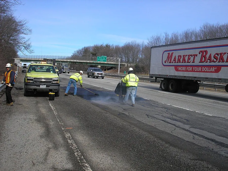 MassDOT crew repairs potholes on Interstate 93 southbound near River Road in the Andover/Methuen area…